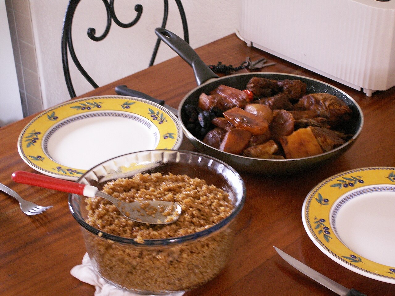 A home-cooked spread of thieboudienne with rice and braised fish